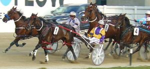 Rocker Band makes run run three wide at the 1000m outside Lightning Mach, Democrat Party (parked) and eventual winner Tangos Delight (trail) at Addington on Friday, February 12.